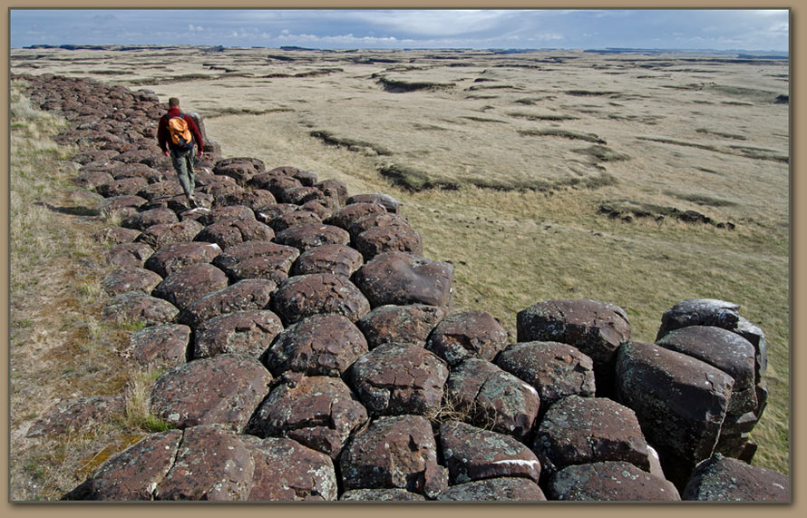 Geologist Nick Zentner walks over columnar basalt in the Drumheller Channels.