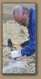 Geologist Vic Baker collects small sample of material from Ice Age Floods erratic boulder. .
